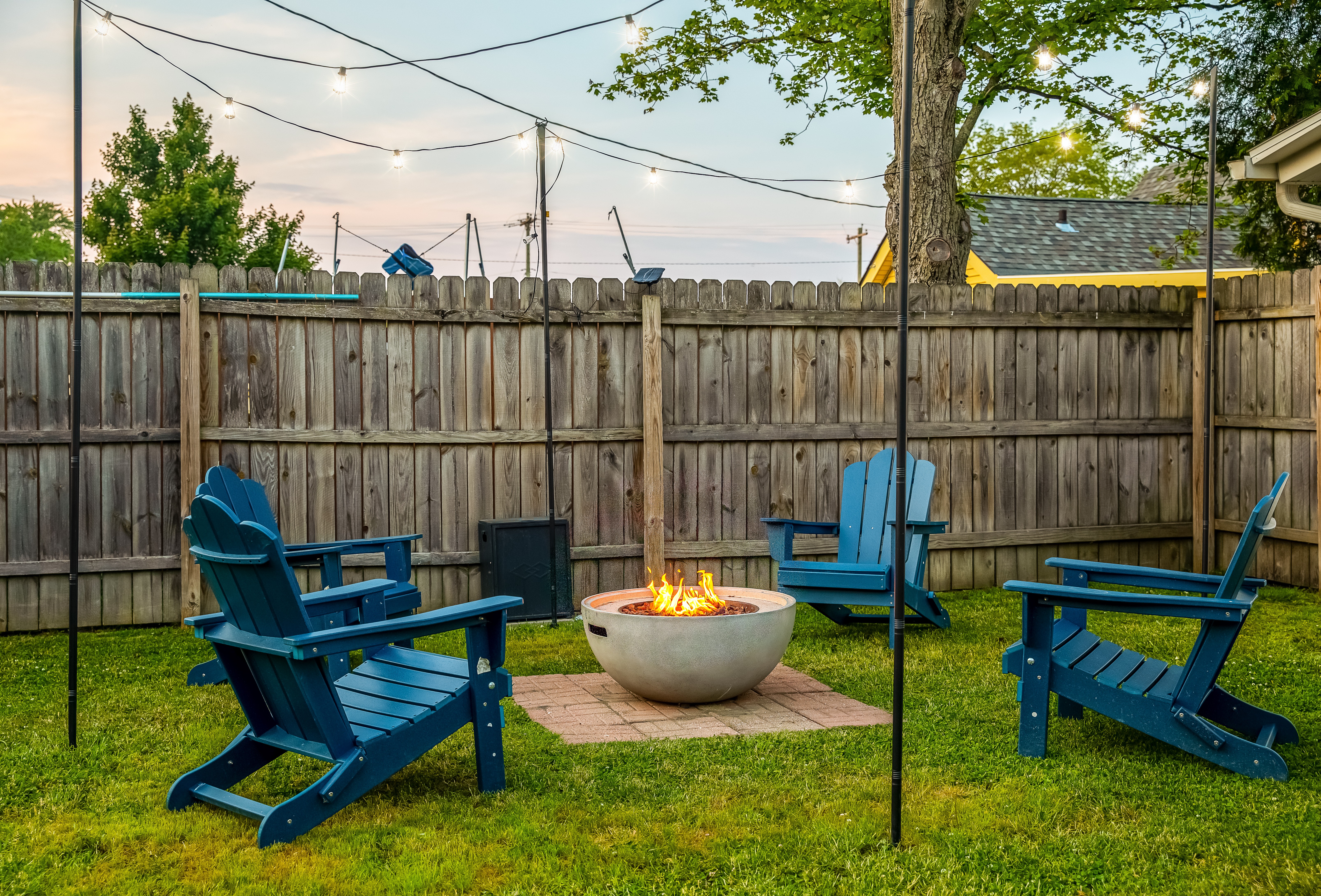 Backyard fire pit with string lights